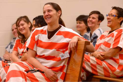 Leah Hogsten  |  The Salt Lake Tribune
Kristie Nuneviller (center) and her fellow inmates laugh as Judge Thomas Kay shares his comedic thoughts about his poetry. On Christmas Day, 2nd District Court Judge Thomas Kay and his wife Kathy read a Christmas story and poems Judge Kay has written to Davis County Jail inmates. Thursday, December 25, 2014 in Farmington, Utah.