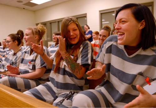 Leah Hogsten  |  The Salt Lake Tribune
l-r Saylee Cutler and Whitney Waters draw giggles from fellow inmates as they become animated singing "Jingle Bells." On Christmas Day, 2nd District Court Judge Thomas Kay and his wife Kathy read a Christmas story and poems Judge Kay has written to Davis County Jail inmates. Thursday, December 25, 2014 in Farmington, Utah.