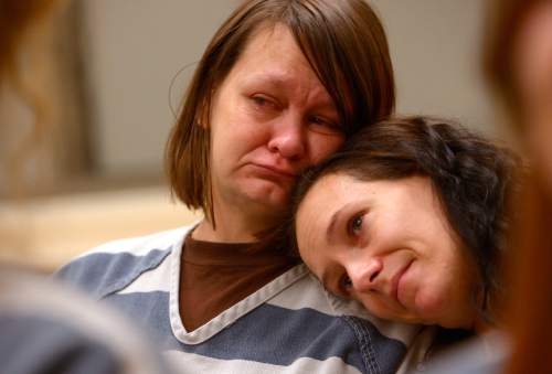 Leah Hogsten  |  The Salt Lake Tribune
l-r Marcella Ginn and Jennifer Martin as they listen to their fellow inmates sing "Silent Night." On Christmas Day, 2nd District Court Judge Thomas Kay and his wife Kathy read a Christmas story and poems Judge Kay has written to Davis County Jail inmates. Thursday, December 25, 2014 in Farmington, Utah.
