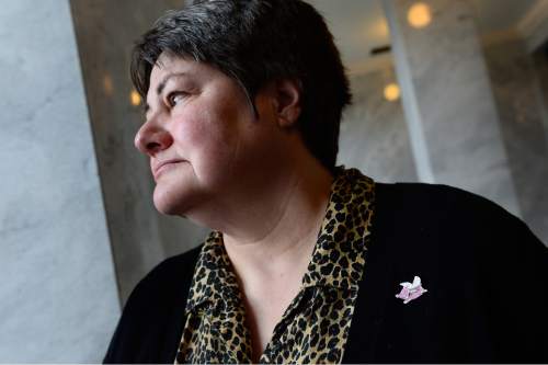 Scott Sommerdorf   |  The Salt Lake Tribune
Kate Call wears a "When Pigs Fly" pin as she visits the Utah State Capitol, Sunday, Dec. 21, 2014. Her wife, Karen Archer, was too ill to make the trip.