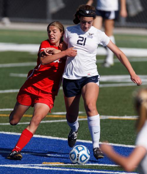 Trent Nelson  |  The Salt Lake Tribune
East's 36 and Skyline's Rachel Gordon fight for the ball, as East faces Skyline High School in a 4A girls state soccer semifinal match, Tuesday October 22, 2013.