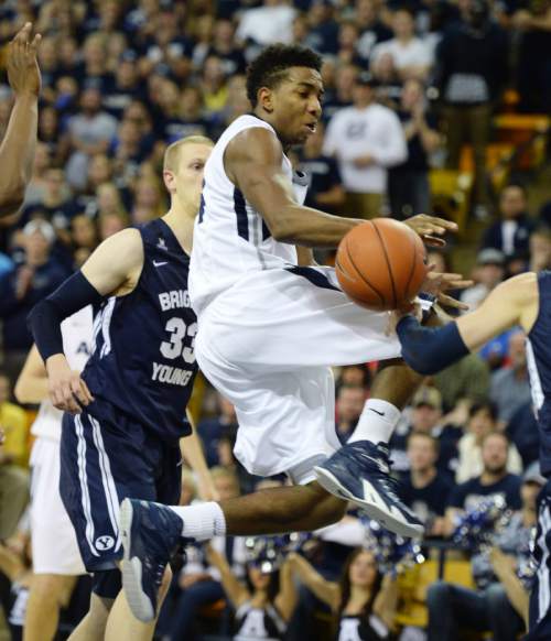 Steve Griffin  |  The Salt Lake Tribune

Utah State Aggies guard Chris Smith (34) gets stripped of the ball as he tries to get to the basket during second half action against  BYU in Logan, Tuesday, December 2, 2014.