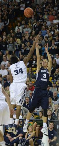 Steve Griffin  |  The Salt Lake Tribune

Brigham Young Cougars guard Tyler Haws (3) lets the ball fly as he shoots over Utah State Aggies guard Chris Smith (34) during first half action in the BYU versus USU men's basketball game in Logan, Tuesday, December 2, 2014.