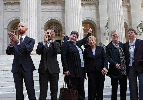 Brennan Linsley  |  The Associated Press
Plaintiffs challenging Utah's gay marriage ban, from left, Derek Kitchen, his partner Moudi Sbeity, Kate Call, her partner Karen Archer, Laurie Wood and her partner Kody Partridge stand together after leaving court following a hearing at the U.S. Circuit Court of Appeals in Denver in April. The court is to decide if it agrees with a federal judge in Utah who in mid-December overturned a 2004 voter-passed gay marriage ban, saying it violates gay and lesbian couples' rights to due process and equal protection under the 14th Amendment.