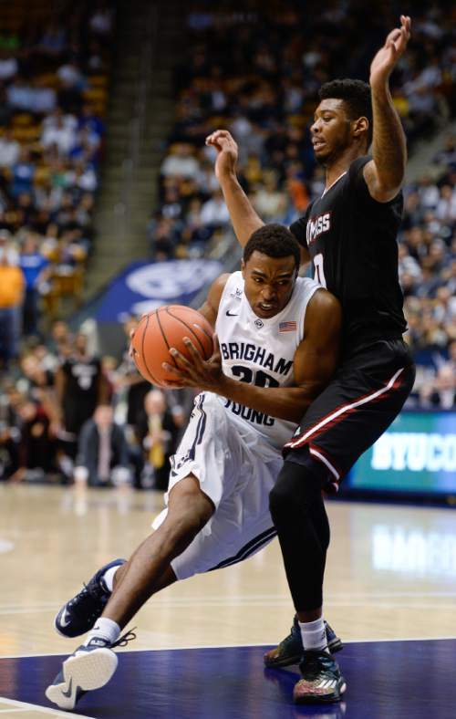 Francisco Kjolseth  |  The Salt Lake Tribune
BYU' Anson Winder pushes past Donte Clark of UMass in game action at the Marriott Center in Provo on Tuesday, Dec. 23, 2014.