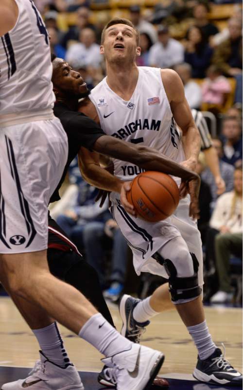 Francisco Kjolseth  |  The Salt Lake Tribune
BYU's Kyle Collinsworth loses control of the ball to  Jabarie Hinds of UMass in game action at the Marriott Center in Provo on Tuesday, Dec. 23, 2014.