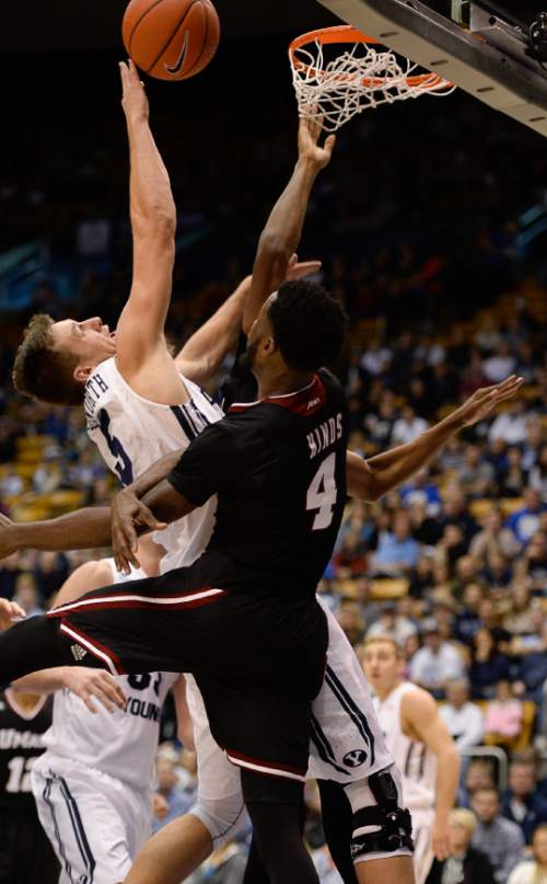 Francisco Kjolseth  |  The Salt Lake Tribune
BYU's Kyle Collinsworth pushes past Jabarie Hinds of UMass in game action at the Marriott Center in Provo on Tuesday, Dec. 23, 2014.