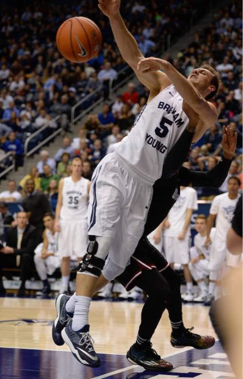 Francisco Kjolseth  |  The Salt Lake Tribune
BYU's Kyle Collinsworth tries to regain control of a rebound against UMass at the Marriott Center in Provo on Tuesday, Dec. 23, 2014.