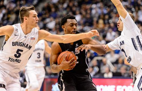 Trent Nelson  |  The Salt Lake Tribune
Gonzaga Bulldogs guard Byron Wesley (22) drives between Brigham Young Cougars guard Kyle Collinsworth (5) and guard Chase Fischer (1) as BYU hosts Gonzaga, men's college basketball at the Marriott Center in Provo, Saturday December 27, 2014.