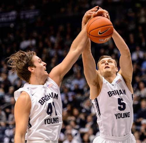 Trent Nelson  |  The Salt Lake Tribune
Brigham Young Cougars forward Luke Worthington (41) and Brigham Young Cougars guard Kyle Collinsworth (5) pull down a rebound as BYU hosts Gonzaga, men's college basketball at the Marriott Center in Provo, Saturday December 27, 2014.