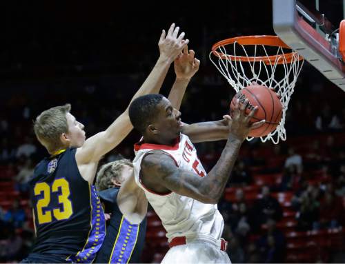 Utah guard Delon Wright, right, pulls down a rebound as South Dakota State guard Reed Tellinghuisen (23) defends in the first half during an NCAA college basketball game Tuesday, Dec. 23, 2014, in Salt Lake City. (AP Photo/Rick Bowmer)