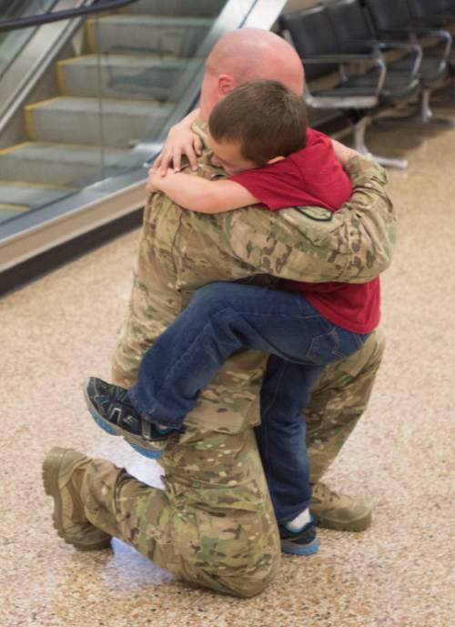 Steve Griffin  |  The Salt Lake Tribune


Jack Curzou hugs his father 1st Lt. Lance Curzou, of the Utah Army National Guard's 204th Maneuver Enhancement Brigade, as he returns to Utah from a 10-month deployment to Afghanistan. Lance was met by his children Jack, Camden, Ruby and his wife Amy.  The mission of the 204th was to conduct base operations and base defense for U.S. military installations in Northern Afghanistan in support of Operation Enduring Freedom.  Soldiers returned home at the Salt Lake International Airport in Salt Lake City, Utah Friday, January 24, 2014.