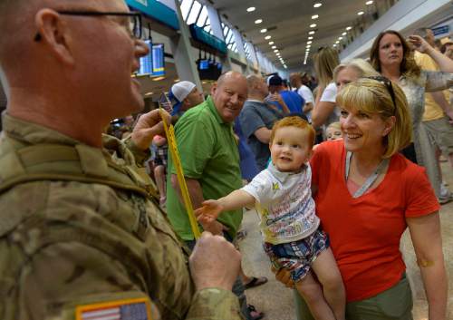 Scott Sommerdorf   |  The Salt Lake Tribune
22 month old Hudson Hawkins beams up at his grandfather, Chief William Erickson as he returned from a 12-month deployment to Afghanistan. Members of the Guard's 65th Field Artillery Brigade were greeted by their loved ones at Salt Lake City International Airport, Saturday, May 31, 2014.
