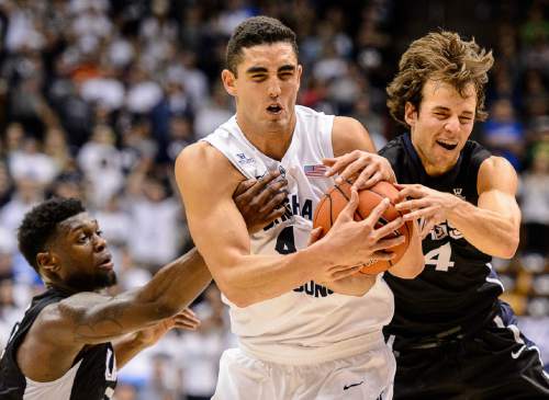 Gonzaga guard Gary Bell Jr. (5), BYU center Corbin Kaufusi, center, and Gonzaga guard Kevin Pangos (4) scramble for the ball during an NCAA college basketball game in Provo, Utah, Saturday, Dec. 27, 2014. (AP Photo/The Salt Lake Tribune, Trent Nelson) DESERET NEWS OUT; LOCAL TELEVISION OUT; MAGAZINES OUT
