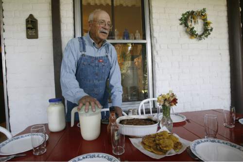 Cecil Garland sits down for lunch on the patio of his home on his ranch in Callao, Friday, August 21,  2009  Rick Egan/The Salt Lake Tribune