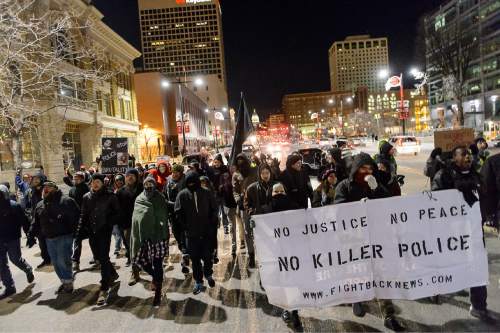 Trent Nelson  |  The Salt Lake Tribune
Approximately sixty protesters walk down State Street following a rally against police brutality in Salt Lake City, Wednesday December 31, 2014.
