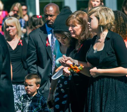 Steve Griffin  |  The Salt Lake Tribune


Susan Hunt is consoled as she follows pallbearers as they carry the casket of her son, Darrien Hunt, following funeral services at the Saratoga Springs North Stake Center in in Saratoga Springs, Utah Thursday, September 18, 2014. Police officers in Saratoga Springs shot and killed Hunt on Sept. 10, 2014.