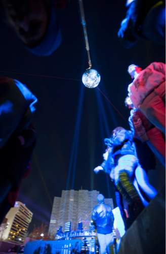 Steve Griffin  |  The Salt Lake Tribune


A giant MirrorBall spins in the night sky as Salt Lake rings in the new year during Eve celebrations at the Salt Palace Convention Center in Salt Lake City, Wednesday, December 31, 2014. Officials with the Downtown Alliance say this massive installation is the largest mirrored sphere in the United States. It is 20 ft in diameter, more than 60 ft in circumference and built with 1200 square mirrors. MirrorBall weighs in at 2433 lbs.