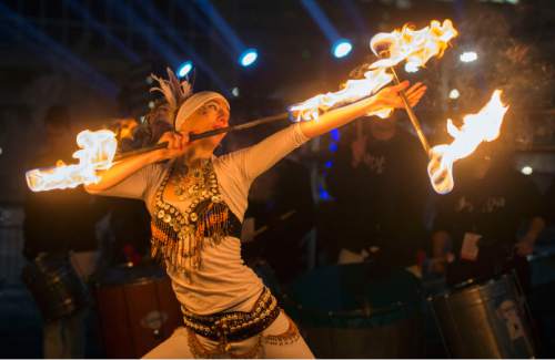 Steve Griffin  |  The Salt Lake Tribune


Sambafogo play music and fire dance as Salt Lake rings in the new year during Eve celebrations at the Salt Palace Convention Center in Salt Lake City, Wednesday, December 31, 2014. Officials with the Downtown Alliance say this massive installation is the largest mirrored sphere in the United States. It is 20 ft in diameter, more than 60 ft in circumference and built with 1200 square mirrors. MirrorBall weighs in at 2433 lbs.