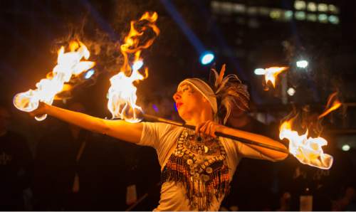 Steve Griffin  |  The Salt Lake Tribune


Sambafogo play music and fire dance as Salt Lake rings in the new year during Eve celebrations at the Salt Palace Convention Center in Salt Lake City, Wednesday, December 31, 2014. Officials with the Downtown Alliance say this massive installation is the largest mirrored sphere in the United States. It is 20 ft in diameter, more than 60 ft in circumference and built with 1200 square mirrors. MirrorBall weighs in at 2433 lbs.