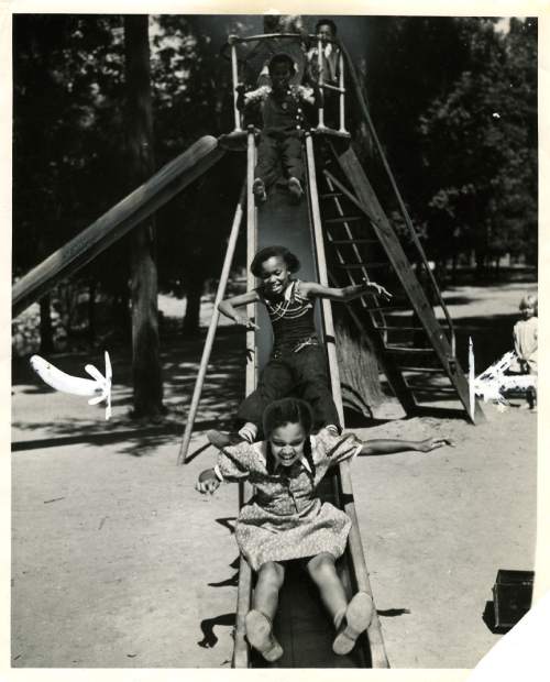 Tribune file photo

Children play on a slide at Liberty Park in this photo dated July 18, 1937.