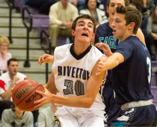 Rick Egan  |  The Salt Lake Tribune

Jeff Aren's (30) Riverton, tries to get a past Joel Bruder (3)  Juan Diego, in the championship game of the Holiday Prep Tournament at Riverton High, Wednesday, December 31, 2014