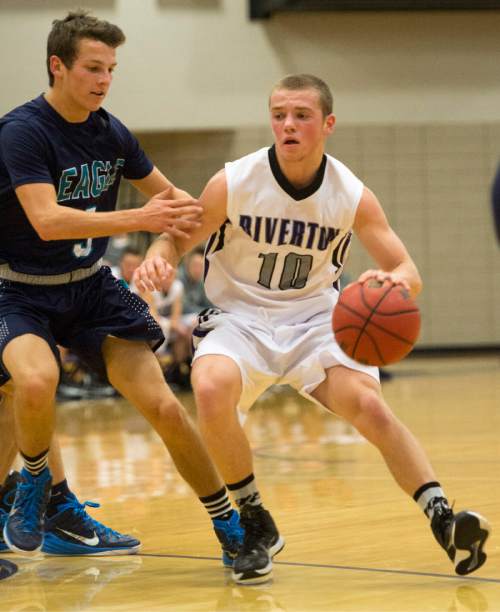 Rick Egan  |  The Salt Lake Tribune

Stetson Rigby(10) Riverton, drives with the ball, as Joel Bruder (3) defends for Juan Diego, in the championship game of the Holiday Prep Tournament at Riverton High, Wednesday, December 31, 2014