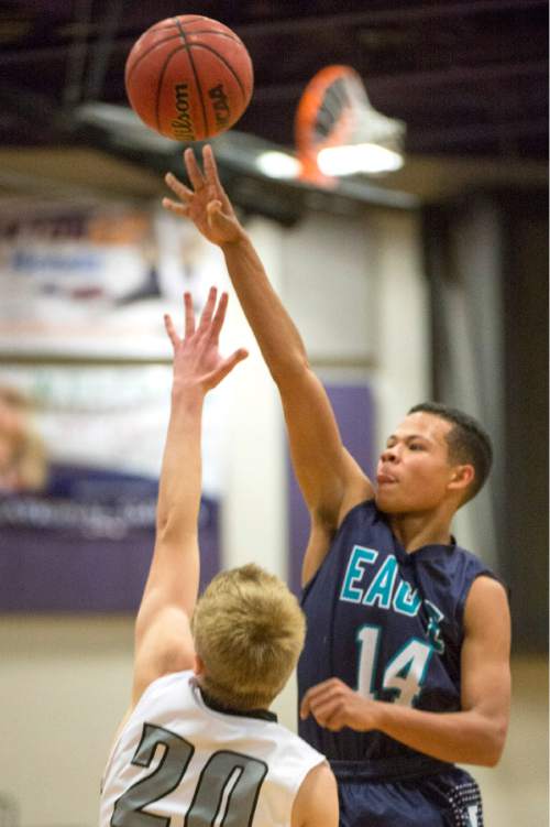Rick Egan  |  The Salt Lake Tribune

Avery Ames (14) Juan Diego, shoots over Joey Andrews, Riverton, in the championship game of the Holiday Prep Tournament at Riverton High, Wednesday, December 31, 2014