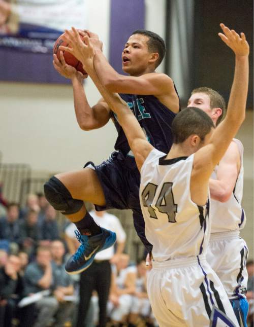 Rick Egan  |  The Salt Lake Tribune

Avery Ames (14) Juan Diego, tries to score as Dakota Rodriguez (44) defends for Riverton, in the championship game of the Holiday Prep Tournament at Riverton High, Wednesday, December 31, 2014