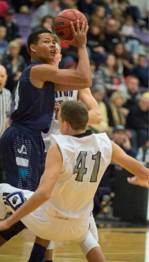 Rick Egan  |  The Salt Lake Tribune

Avery Ames (14) Juan Diego, collides with Chase Eggett (41) Riverton, in the championship game of the Holiday Prep Tournament at Riverton High, Wednesday, December 31, 2014