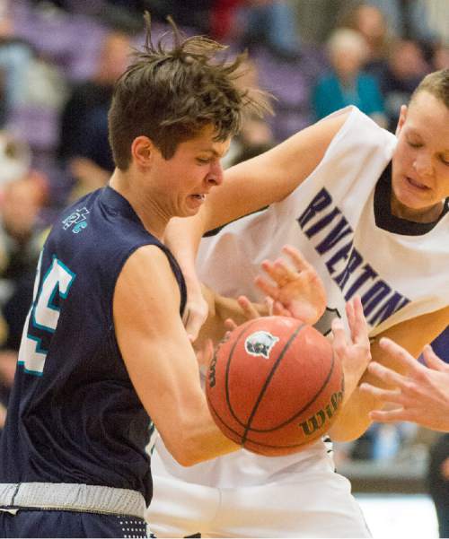 Rick Egan  |  The Salt Lake Tribune

Zach Nickles (25) Juan Diego, wrestles the ball from the hands of  Chase Eggett (41), Riverton, in the championship game of the Holiday Prep Tournament at Riverton High, Wednesday, December 31, 2014