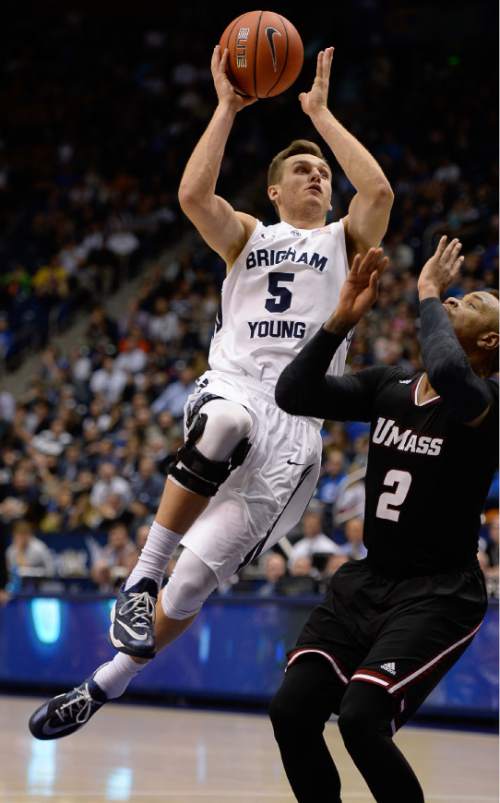 Francisco Kjolseth  |  The Salt Lake Tribune
BYU's Kyle Collinsworth tries drives the ball past Derrick Gordon of UMass at the Marriott Center in Provo on Tuesday, Dec. 23, 2014.