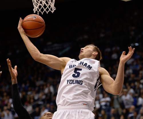 Francisco Kjolseth  |  The Salt Lake Tribune
BYU's Kyle Collinsworth tries to regain control of a rebound against UMass at the Marriott Center in Provo on Tuesday, Dec. 23, 2014.