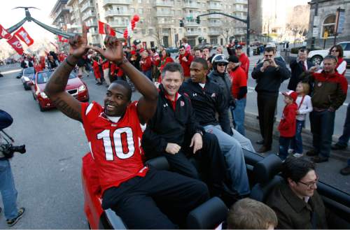 Salt Lake City - Utah's Stevenson Sylvester, coach Kyle Whittingham and quarterback Brian Johnson greet the crowds as the University of Utah's unforgettable 2008 football season officially ends on Friday, Jan. 16, 2009 with large crowds of fans descending on downtown Salt Lake City for a team that won 13 straight games in every conceivable manner.  Photo by Francisco Kjolseth/The Salt Lake Tribune 01/16/2009