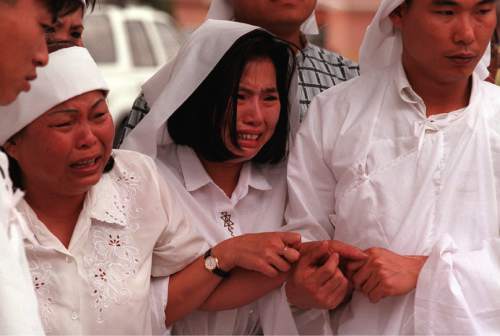 Tim Kelly  |  The Salt Lake Tribune

Mourners attend a funeral in 1997.