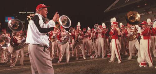 Tim Kelly  |  The Salt Lake Tribune

Utah coach Ron McBride leads the Utah marching band in a song after losing to the Wisconsin Badgers in the Copper Bowl in 1996.