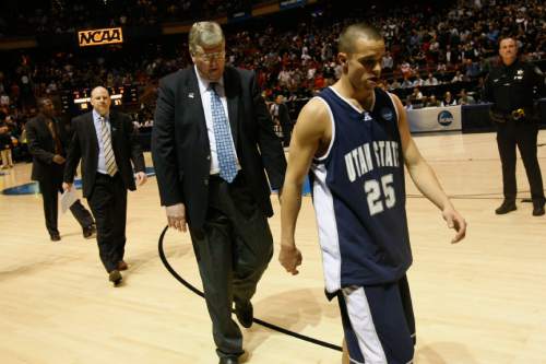Utah State's Jaxon Myaer #25 and Coach Stew Morrill walk off of the court after the game at the Taco Bell ArenaFriday, March20, 2009. Utah State lost the game 58-57. 
Photo by Chris Detrick/The Salt Lake Tribune