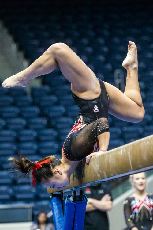 Chris Detrick  |  The Salt Lake Tribune
Utah's Corrie Lothrop competes on the beam during the gymnastics meet at the Marriott Center at Brigham Young University Friday January 9, 2015.