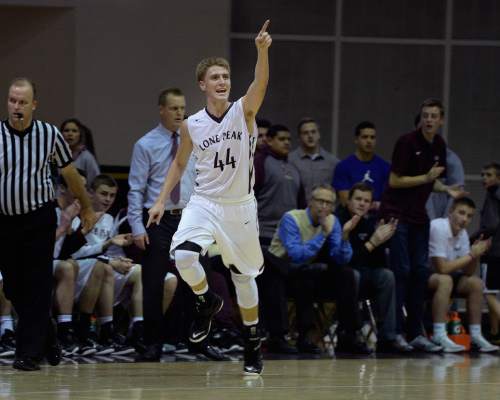 Scott Sommerdorf   |  The Salt Lake Tribune
Lone Peak's Nick Curtis points to the student section after draining a 3-point shot during second half play. Lone Peak defeated Lehi 84-72, Friday, January 9, 2015.