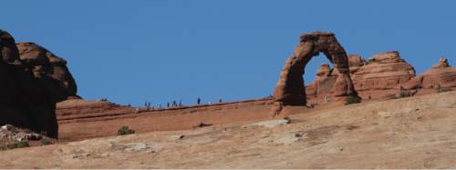 Francisco Kjolseth  |  The Salt Lake Tribune
Visitors get a close up view of Delicate Arch at Arches National Park in southern Utah recently.