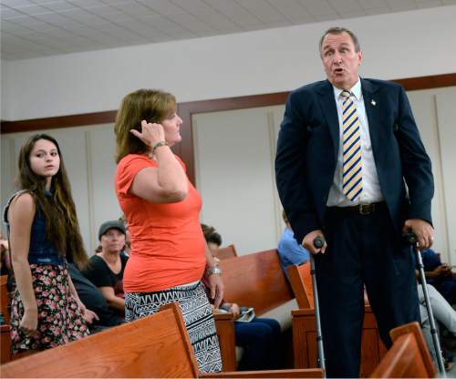 Al Hartmann  |  The Salt Lake Tribune 
Former attorney general Mark Shurtleff using crutches looks for a place to sit in Judge Royal Hansen's courtroom in Salt Lake City Wednesday July 30.  His wife M'Liss, center and daughter Annie accompany him. Shurtleff and former attorney general John Swallow are charged with receiving or soliciting bribes, accepting gifts, tampering with evidence, obstructing justice and participating in a pattern of unlawful conduct.