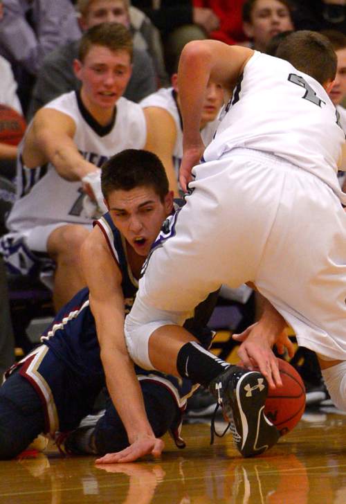 Leah Hogsten  |  The Salt Lake Tribune
Herriman's David Maynard hits the deck while fighting for possession with Riverton's Chase Eggett. Riverton High School boys basketball team defeated Herriman High School 53-49 at the during their game Tuesday January 13, 2015.