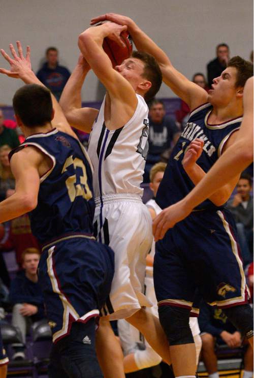 Leah Hogsten  |  The Salt Lake Tribune
Riverton's Spencer Anderson is fouled by Herriman's Devin Wilkins (right) and pressured by David Maynard (left). Riverton High School boys basketball team trails Herriman High School 28-23 at the half during their game Tuesday January 13, 2015.