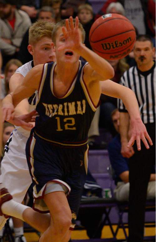 Leah Hogsten  |  The Salt Lake Tribune
Herriman's Stockton Enger grabs control of a loose ball under the pressure of Riverton's Joey Andrews. Riverton High School boys basketball team defeated Herriman High School 53-49 at the during their game Tuesday January 13, 2015.