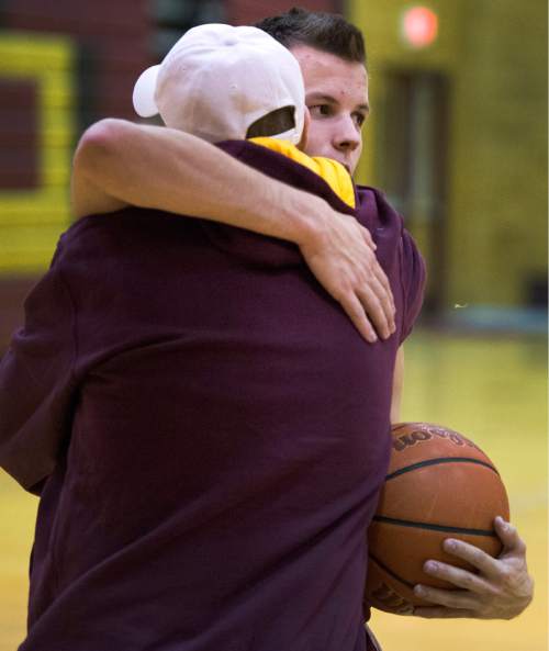 Rick Egan  |  The Salt Lake Tribune

Darin Richins hugs his son, Viewmont  basketball player, Josh Richins, in the Viewmont High Gym, Monday, December 15, 2014