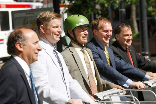 Al Hartmann  |  The Salt Lake Tribune
UTA General Manager Mike Allegra, left,  Jonathan Johnson, chairman of the Salt Lake Chamber of Commerce's Clean Air Task Force, Salt Lake City Mayor Ralph Becker, Salt Lake County Mayor Ben McAdams, and Utah Governor Gary Herbert, pose on green bikes following a press conference in downtown Salt Lake City Wednesday June 19 to issue the fifth annual Clear the Air Challenge to encourage Utahns to reduce air pollution by driving less and using mass transit more.