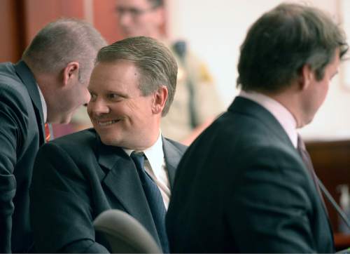 Al Hartmann  |  The Salt Lake Tribune
Stephen R. Jenson, center, smiles at person in the audience during his trial in Salt Lake City on Wednesday, January 14, 2015. He and his brother, Marc Sessions Jenson, are charged with defrauding investors in a luxury ski resort near Beaver, Utah.
