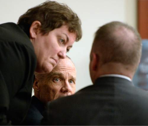 Al Hartmann  |  The Salt Lake Tribune

Marc Sessions Jenson, center, confers with his lawyers Helen Redd, left, and Marcus Mumford as they wait for proceedings to begin in Salt Lake City on Wednesday, January 14, 2015. They are charged with defrauding investors in a luxury ski resort near Beaver, Utah.