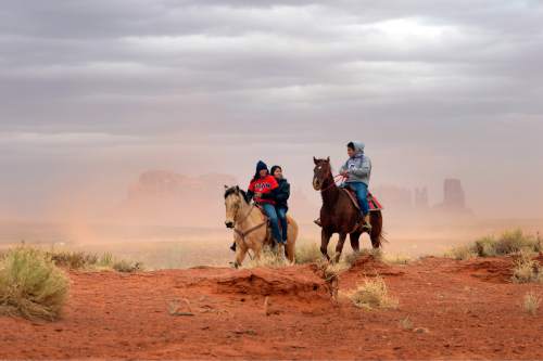 Rick Egan  | The Salt Lake Tribune 

Jaydon Yazzie, VanteJren Atene, and  McKalette Clark ride home from Monument Valley High School on their horses, Thursday, January 30, 2014.