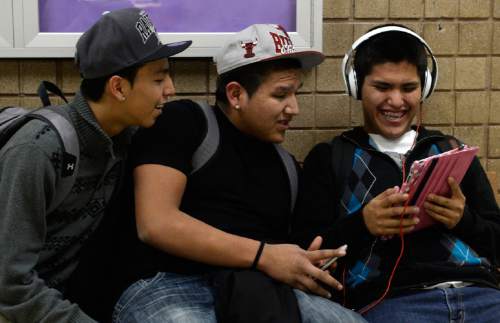 Rick Egan  | The Salt Lake Tribune 

Sergio Morales, Kurtis Holiday, Kevin Bedonie watch YouTube videos on an iPad after school at  Monument Valley High School on Thursday, January 30, 2014.
